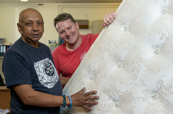 Two men from Highland Blindcraft with a mattress