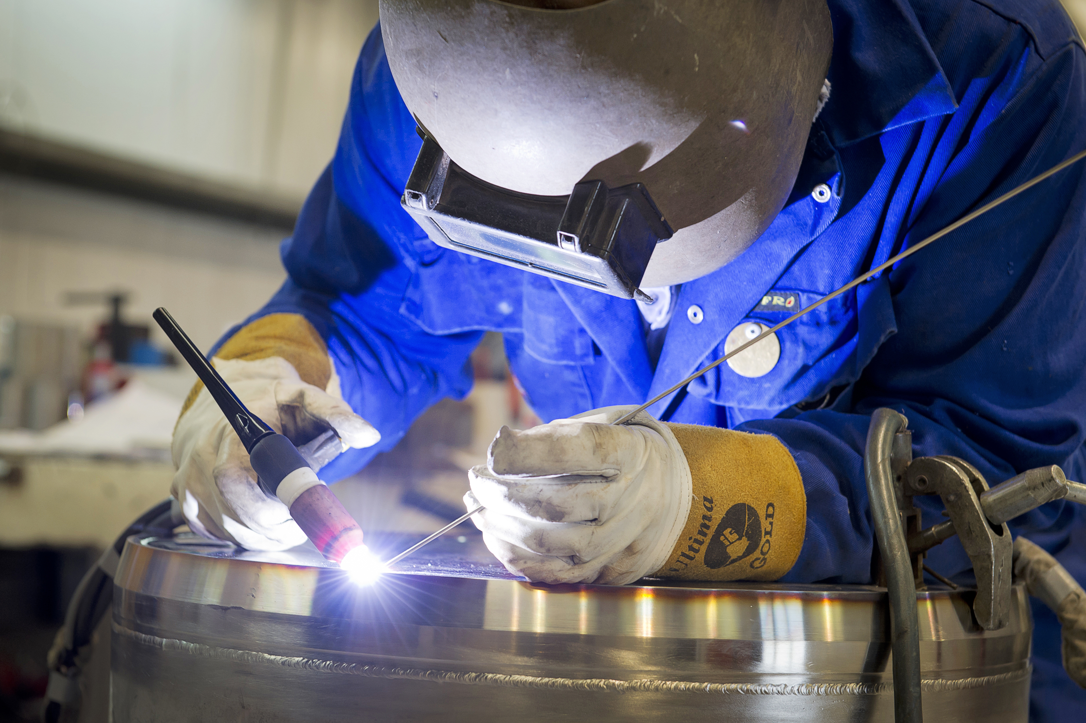 A man soldering at JGC in Caithness 