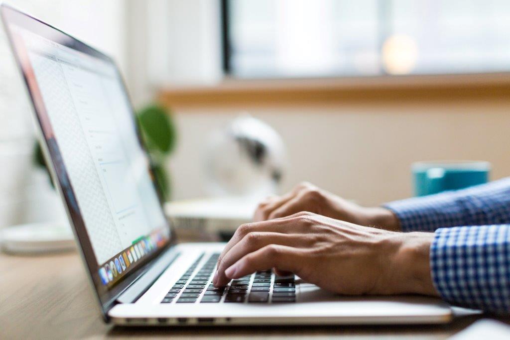 Person typing on laptop