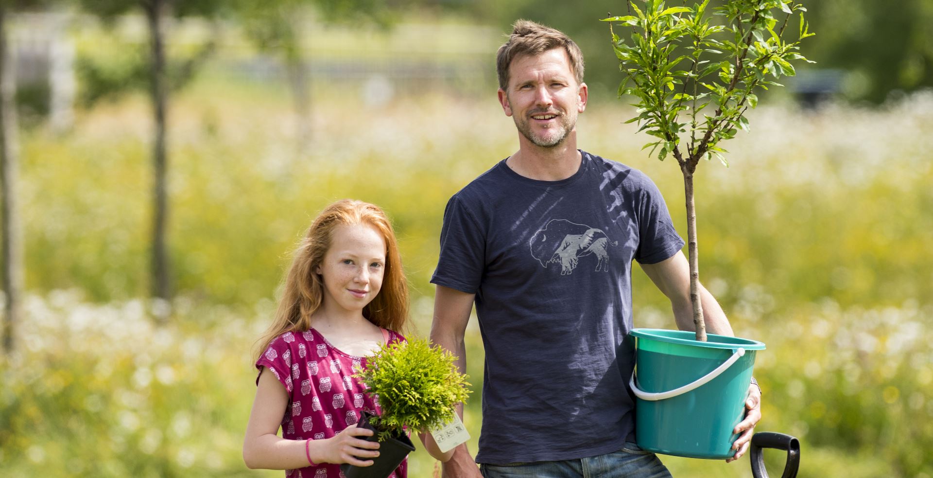 Man and young girl working in garden
